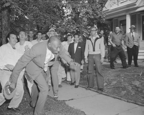 A reporter from the Tri-State Defender, Alex Wilson, is shoved by an angry mob of white people near Central High School in Little Rock, Ark., Sept. 23, 1957. The fight started when nine black students gained entrance to the school as the Army enforced integration. (AP Photo)