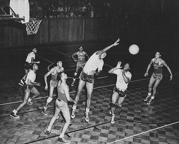 Earl Lloyd, the first black player in the NBA, lived in Institute and played for the West Virginia State College Yellow Jackets from 1946-50. Earl Lloyd is at center in this photograph from 1949, courtesy of West Virginia State University Archives.