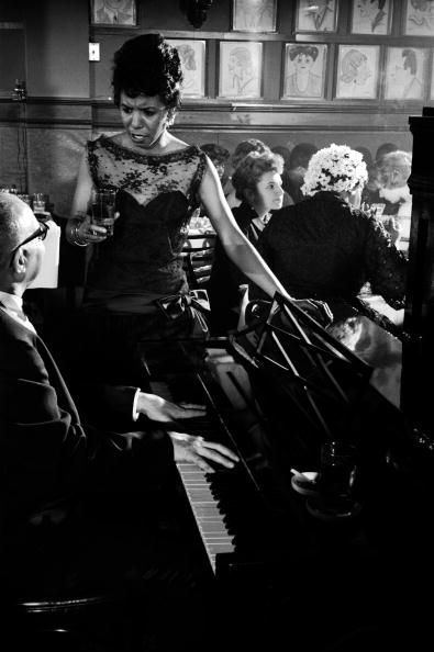 Lorraine Hansberry is captured by Gordon Parks chatting with the pianist at a party in honor of her play ‘A Raisin in the Sun,’ at the now legendary Manhattan restaurant, Sardi’s in March 1959. Photo: Gordon Parks/Time Life Pictures/Getty Images