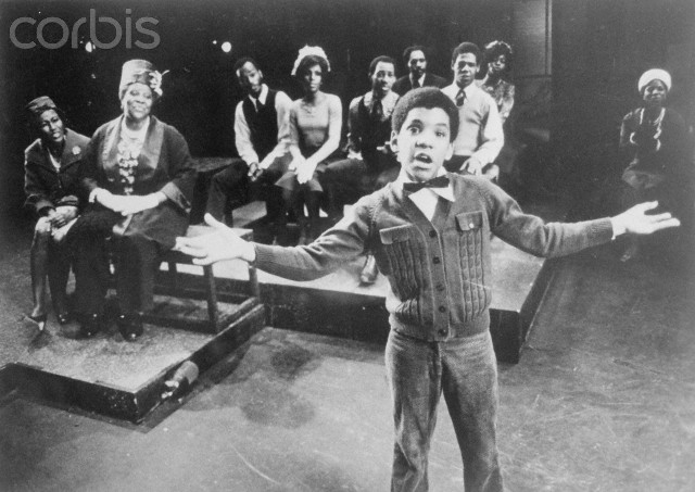 Ralph Carter, (foreground), and Virginia Capers along with Ernestine Jackson, (R), his proud grandmother and mother, are shown watching him in this church scene in the new musical Raisin which premiered on October 18, 1973, at the 46th Street Theater. Donald McKayle was the director-choreographer. Robert Nemiroff was the producer.