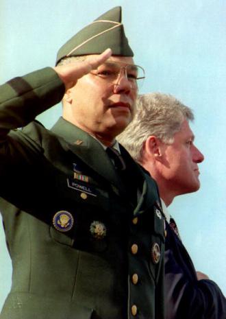 U.S. Gen. Colin Powell salutes as U.S. President B