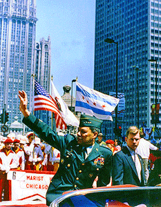 Chairman of the Joint Chiefs of Staff Powell waves to the crowd of a welcome home parade celebrating the end of the Persian Gulf War.